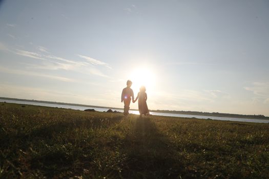 Boy and Girl silhouette in the Nature