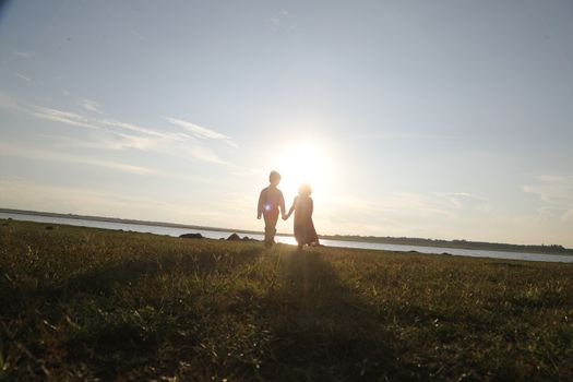 Boy and Girl silhouette in the Nature