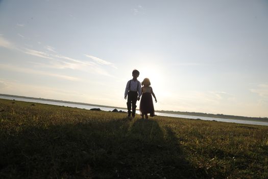 Boy and Girl silhouette in the Nature