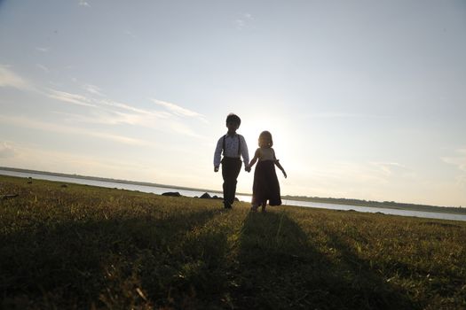 Boy and Girl silhouette in the Nature