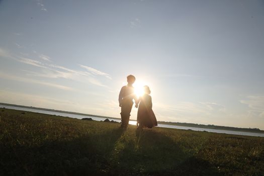Boy and Girl silhouette in the Nature