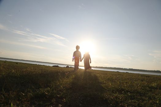 Boy and Girl silhouette in the Nature