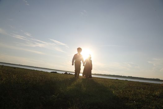 Boy and Girl silhouette in the Nature