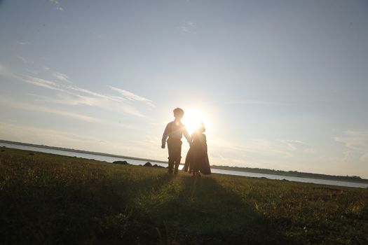 Boy and Girl silhouette in the Nature
