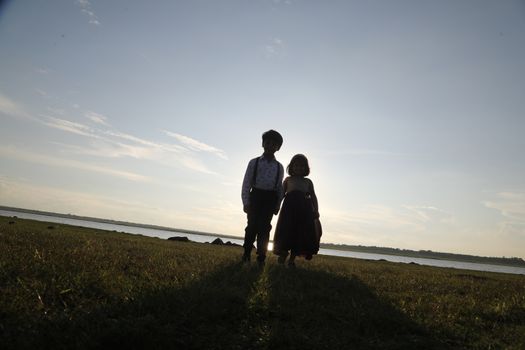 Boy and Girl silhouette in the Nature