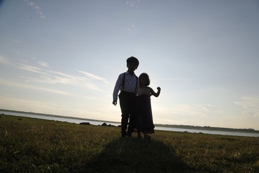 Boy and Girl silhouette in the Nature