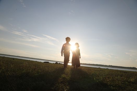 Boy and Girl silhouette in the Nature