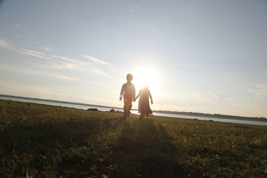 Boy and Girl silhouette in the Nature