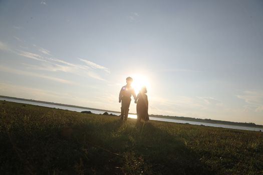 Boy and Girl silhouette in the Nature