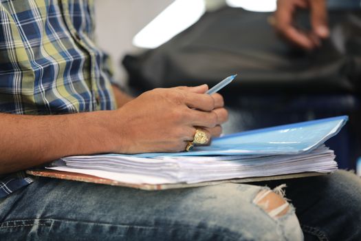 Male Hand with pen and papers
