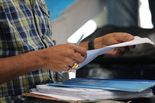 Male Hand with pen and papers