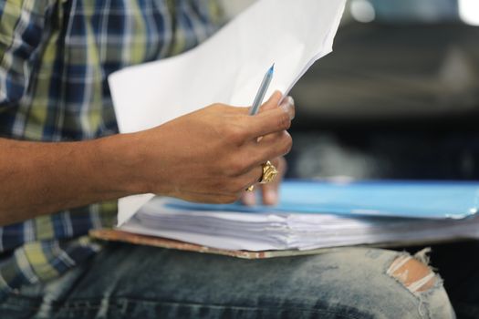 Male Hand with pen and papers