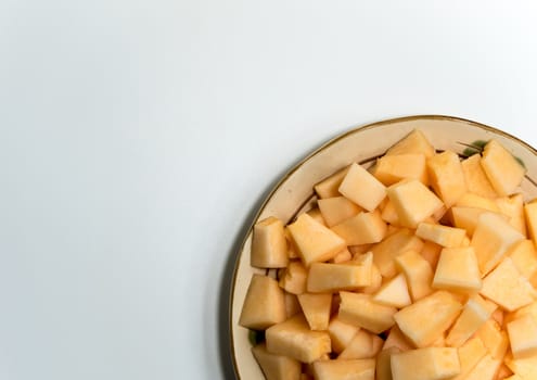 Small pieces of cantaloupe in the ceramic plate