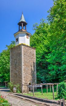 Clock tower in the Etar Architectural Ethnographic Complex in Bulgaria on a sunny summer day. Big size panoramic photo.