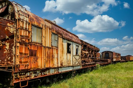 An old abandoned railroad train on tracks