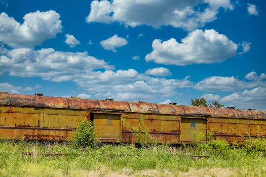 An old abandoned railroad train on tracks