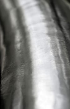 Texture of shiny surface and scratched on stainless steel round bar, industrial grunge background