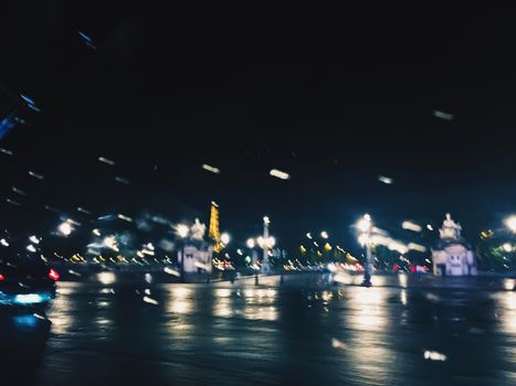 Abstract night city scene in Paris, France, motion blurred lights in the dark