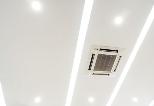 Lighting and ceiling mounted air conditioner on the modern office ceiling