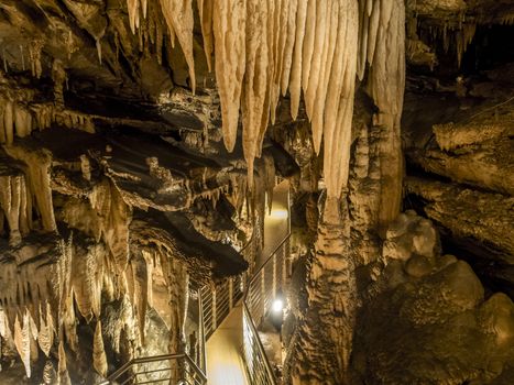 explores cave with stalagmites and stalactites