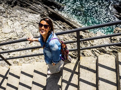 beautiful girl wolking in the National park of Cinque Terre in Liguria, Italy.