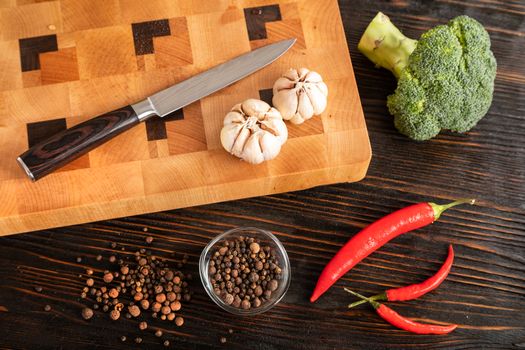 Vegetables and spices on a wooden cutting board