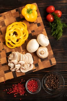 Knife vegetables and spices on a wooden cutting board