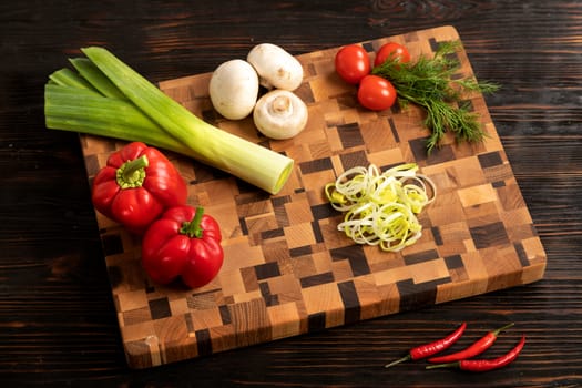 Knife vegetables and spices on a wooden cutting board