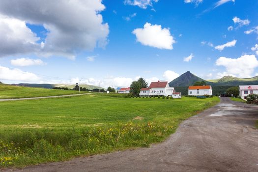 Typical scandinavian landscape with meadows, mountains and village. Lofoten islands, Norway.