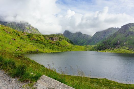 Beautifull scandinavian landscape with meadows, fjord and mountains. Lofoten islands, Norway.