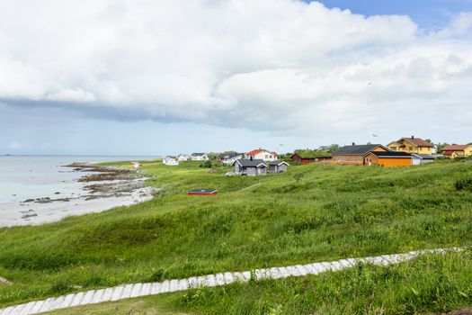 Houses on Rambergstranda beach on Lofoten islands. Beautiful sandy beach and azure water. Norway.