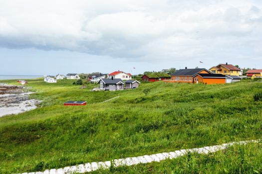 Houses on Rambergstranda beach on Lofoten islands. Beautiful sandy beach and azure water. Norway.