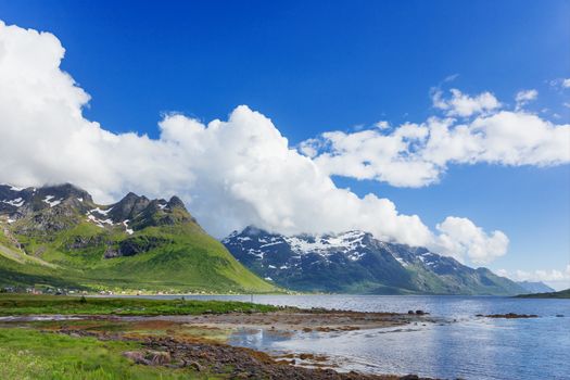 Typical scandinavian landscape with meadows, mountains and fjords. Lofoten islands, Norway.