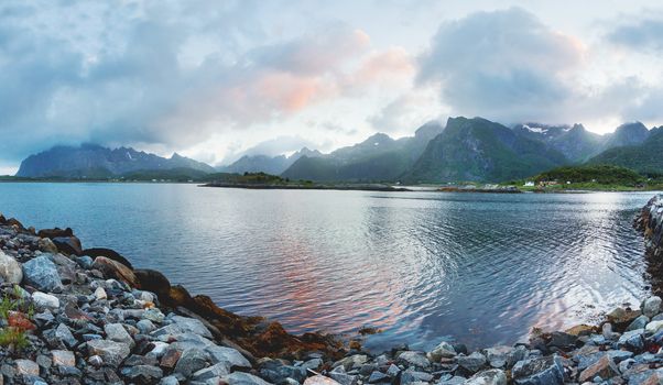 Beautiful sunset scandinavian landscape with village, mountains and fjords. Lofoten islands, Norway.