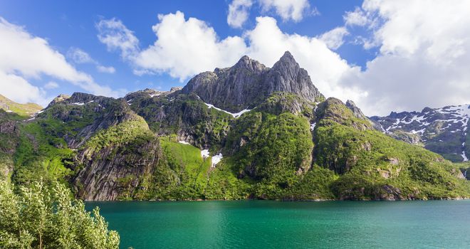 Typical scandinavian landscape with meadows, mountains and fjords. Lofoten islands, Norway.
