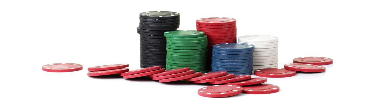 Piles of casino betting chips on white background