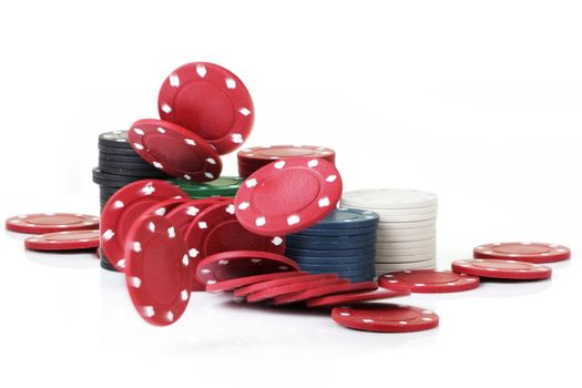 Some betting chips dropping onto white surface with blurred motion