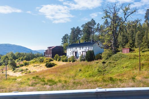 Typical scandinavian landscape with meadows and houses. Norway.
