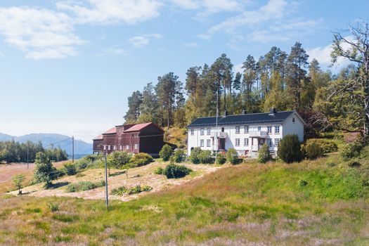 Typical scandinavian landscape with meadows and houses. Norway.
