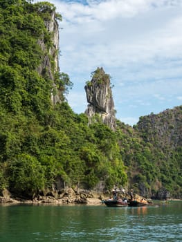 detail of halong bay, rocks and vegetation with blue sky