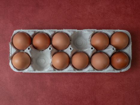 eggs in their box on red background