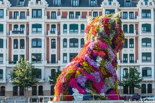 statue of a giant dog covered by flowers