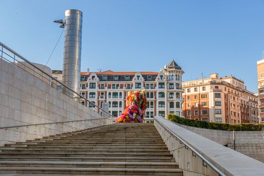 statue of a giant dog covered by flowers