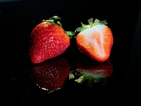 strawberries reflected on black base