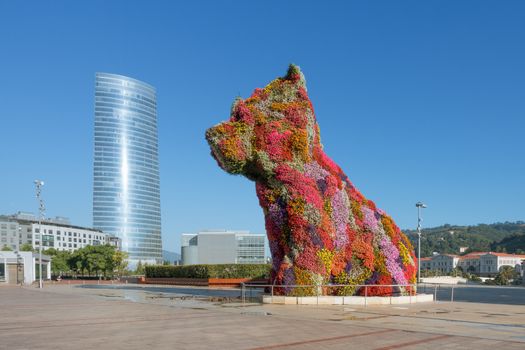 statue of a giant dog covered by flowers