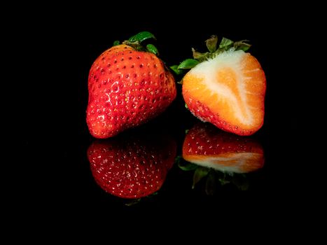 strawberries reflected on black base