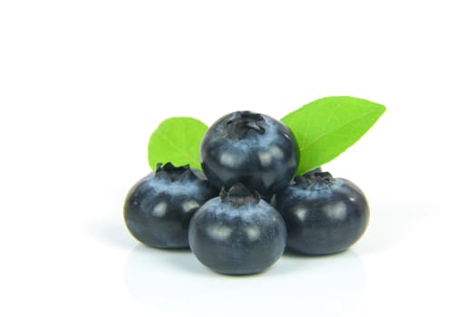 Fresh blueberries with leaves isolated on white background.