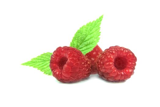 Group of fresh raspberries
with leaves isolated on white background.