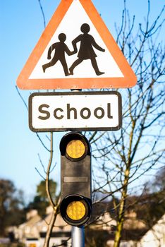 British School roadside warning sign.British School roadside warning sign with tree and blue sky behind