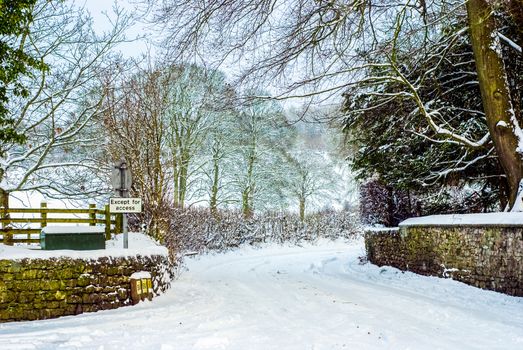 Snowy Road through a Lake District Landscape in Winter UK